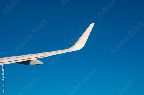 Airplane wing on blue sky