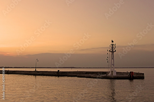 Little lighthouse with birdls in the evening, Odessa, Ukraine. Golden hours © Gelia