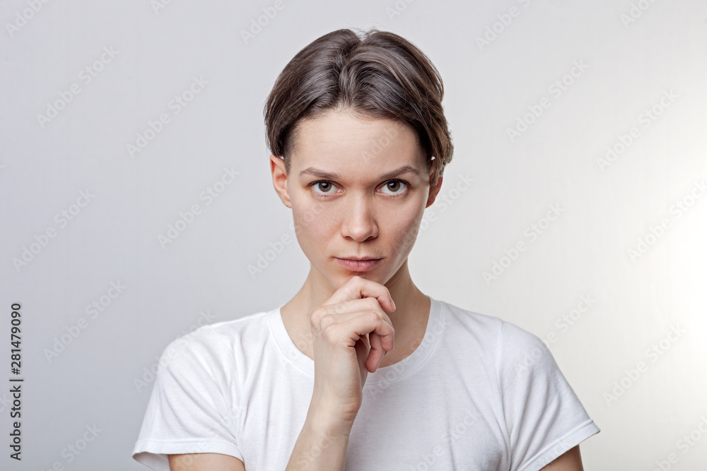 Close up of beautiful, calm, attractive young girl, one arm under the chin, look confident, flirting, seductively, dressed casual, on white background. Close up of beautiful, calm, attractive young girl, one arm under the chin, look confident, flirting, seductively, dressed casual, on white background.
