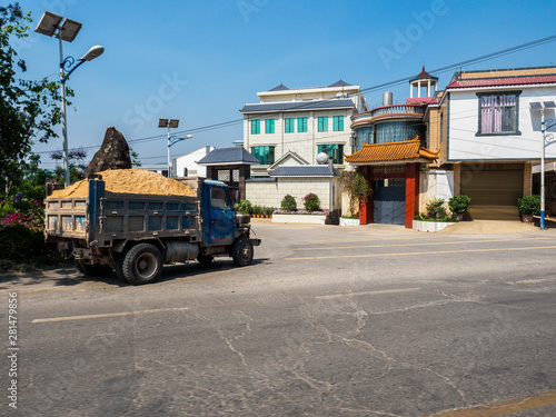 A truck with sand drives through a small village in the Countryside near Kunming in Yunnan Province (China). © Sven