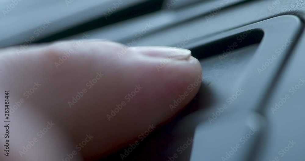 Close up of a finger pushing the aux button on a car dash Close up of a finger pushing the aux button on a car dash