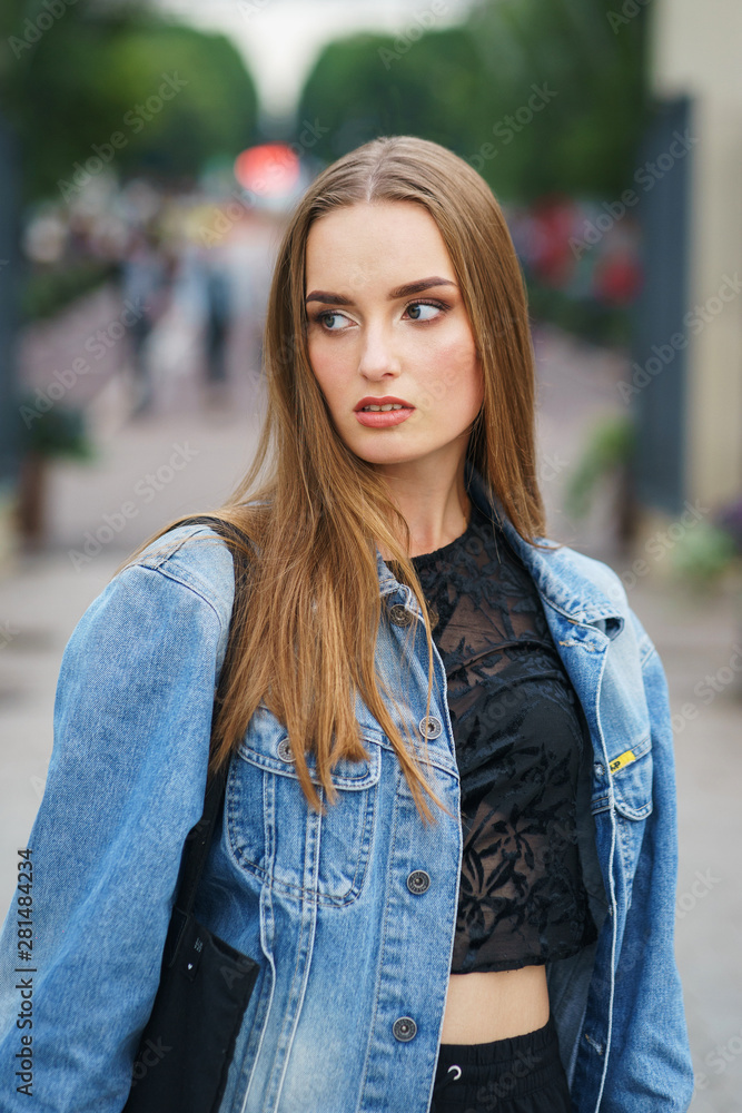 Beautiful model in fashionable clothes in the city park. Beautiful model in fashionable clothes in the city park.