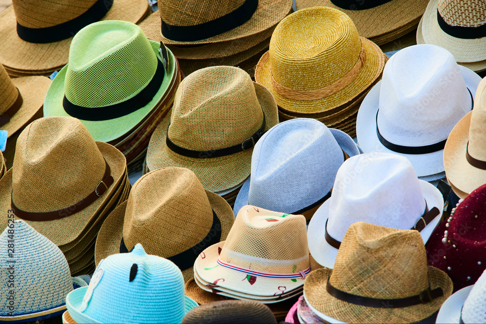 Various hats for sale from a sidewalk vendor