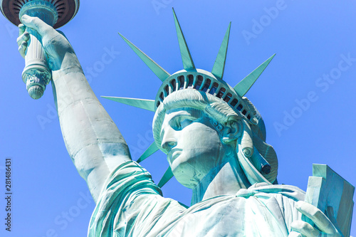 Close view of the Statue of Liberty over blue sky