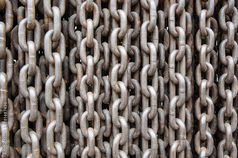 Rusty old brown Iron chains, background. Wall of hanging vertically massive chains. Close-up. Selective focus Rusty old brown Iron chains, background. Wall of hanging vertically massive chains. Close-up. Selective focus
