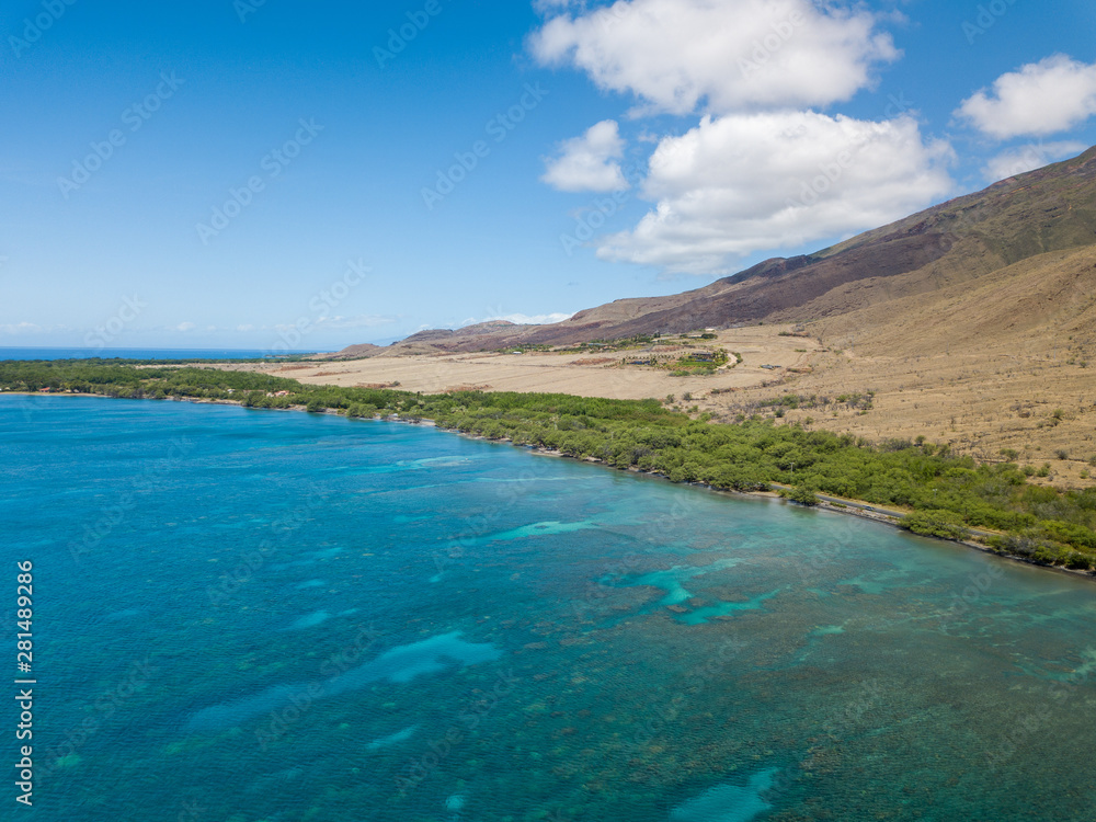 Drone side view of the dry mountains and crystal clear waters of the Lahaina Coast on the island of Maui, Hawaii Drone side view of the dry mountains and crystal clear waters of the Lahaina Coast on the island of Maui, Hawaii