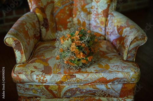 Fake flowers on chintz chair