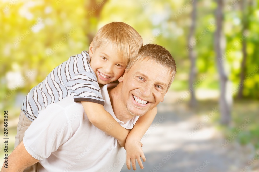 Happy father and son hugging on background Happy father and son hugging on background
