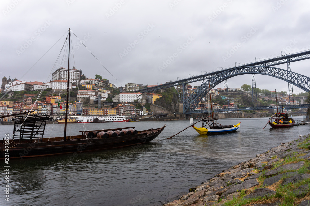 Porto, Portugal old town cityscape on the Douro River with traditional boats.