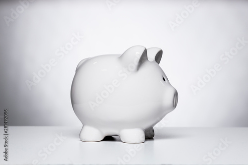 White piggy bank on a white table photo