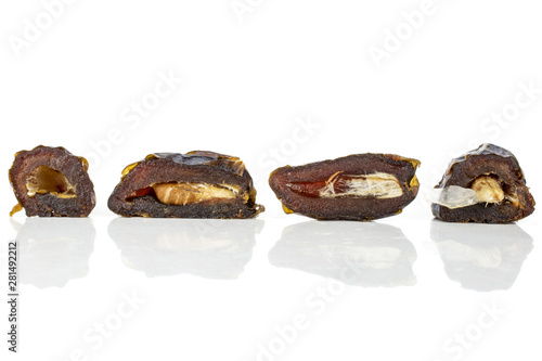 Group of four halves of dried brown date medjool isolated on white background