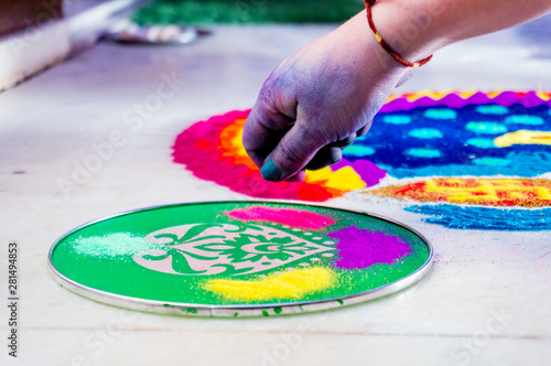 Canvastavla Hand of young indian girl making rangoli from colored powder on diwali eve