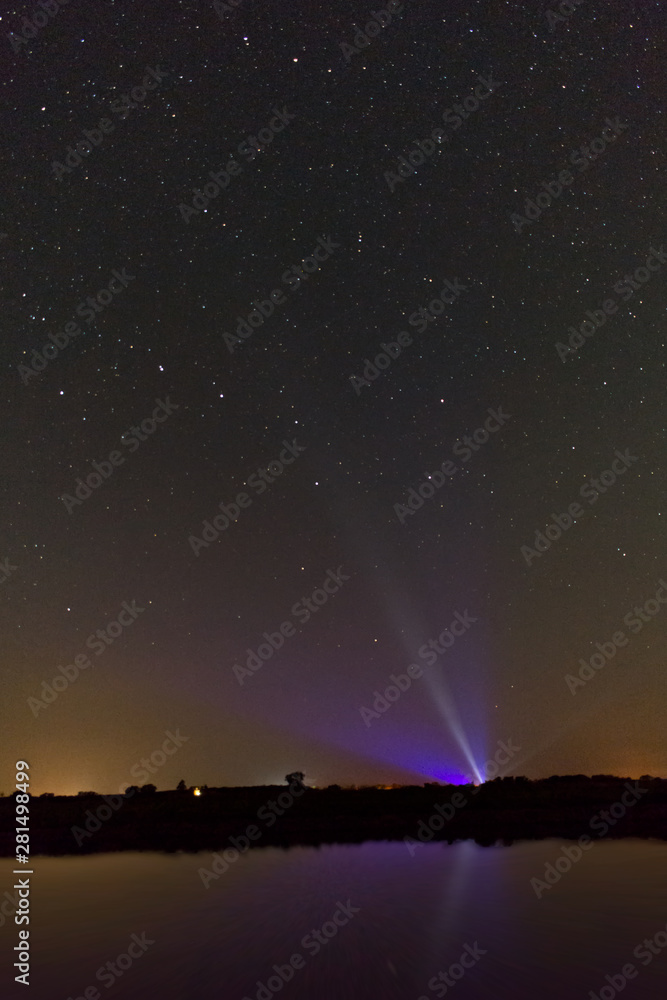 Starry Sky broken by colourful spotlights at Starry Park Westhavelland, Havelaue, Brandenburg, Germany