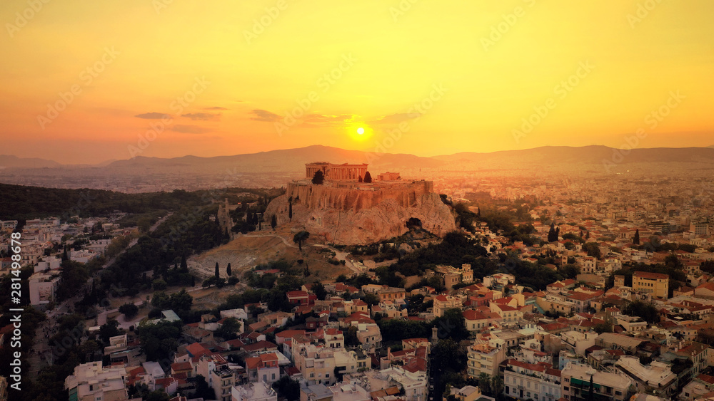 Aerial drone photo of iconic Acropolis hill and the unique masterpiece of Ancient world the Parthenon at sunset with beautiful golden colours, Athens historic centre, Attica, Greece