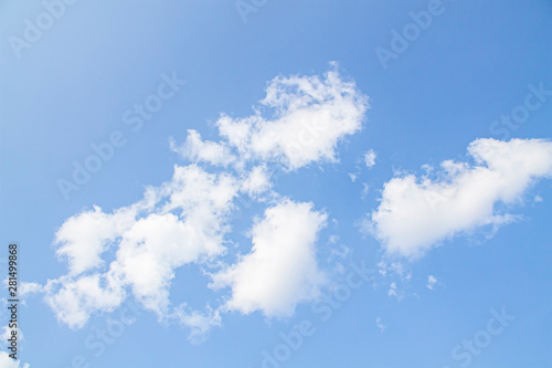 white clouds against the blue sky.