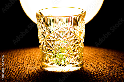 Crystal glass in front of lamp