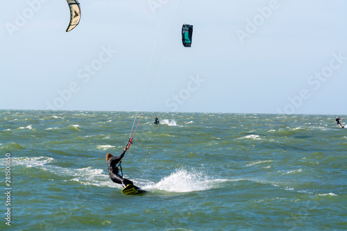 Water sport event, kite surfers race in North Sea near Renesse, Zeeland, Netherlands photo