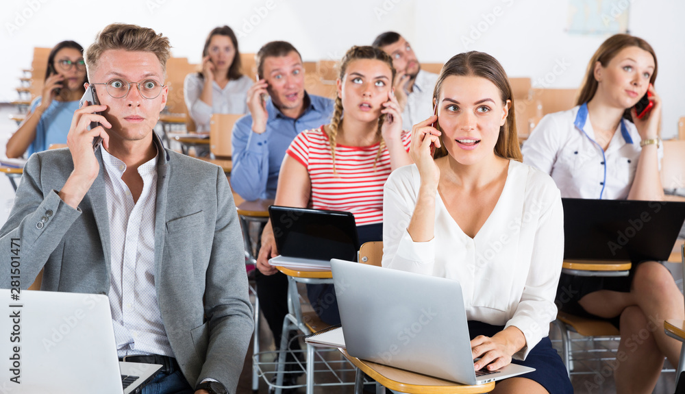 Fototapeta premium Young people talking on phones