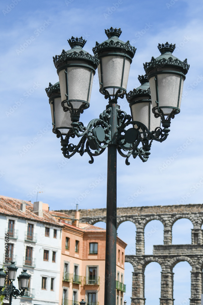 Streetlight in the foreground, with Segovia aqueduct in the background