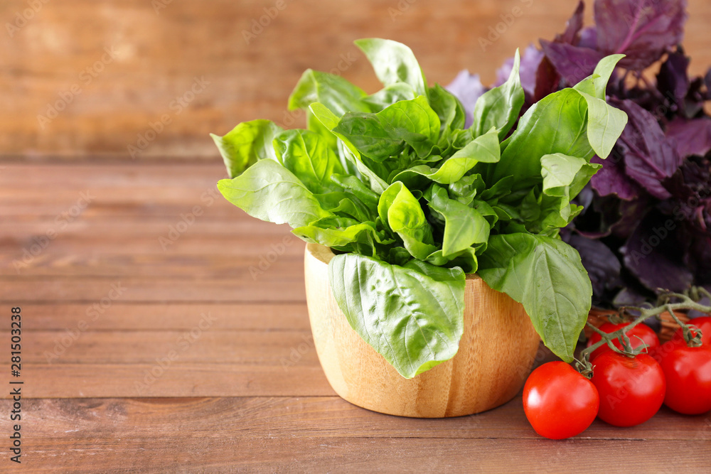Fresh herbs with tomatoes on wooden table Fresh herbs with tomatoes on wooden table