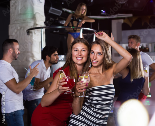 women friends with cocktail dancin