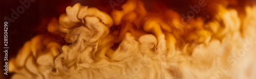 close up view of coffee mixing with milk in glass, panoramic shot