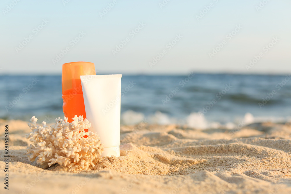 Sunscreen cream with coral on sand beach Sunscreen cream with coral on sand beach