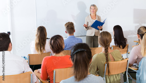 Mature female giving presentation for students