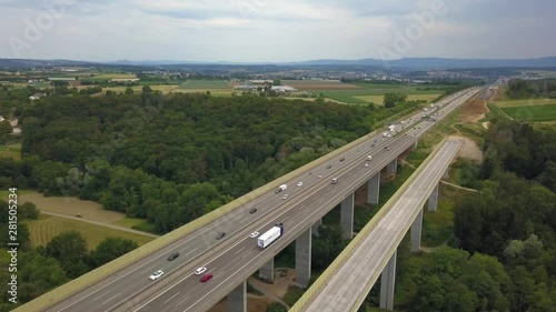 Aerial view of a German Autobahn with construction works for a new railway bridge next to it. Drone footage taken at Denkendorf near Stuttgart - on a weekend, hence not much truck traffic. photo