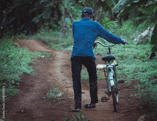 old cambodian man with his bicycle