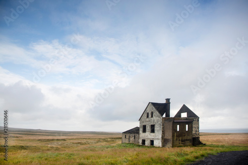 Exterior view of ruin house against cloudy sky