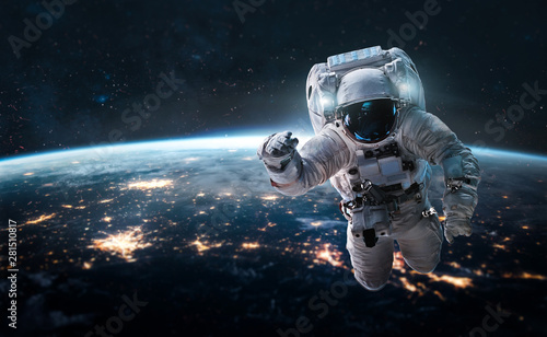 Photographie Astronaut in the outer space over the nightly planet Earth