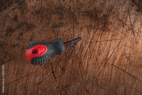 Phillips screwdriver on wooden background