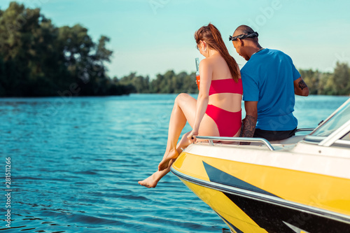 Couple sitting on the bow of a yacht