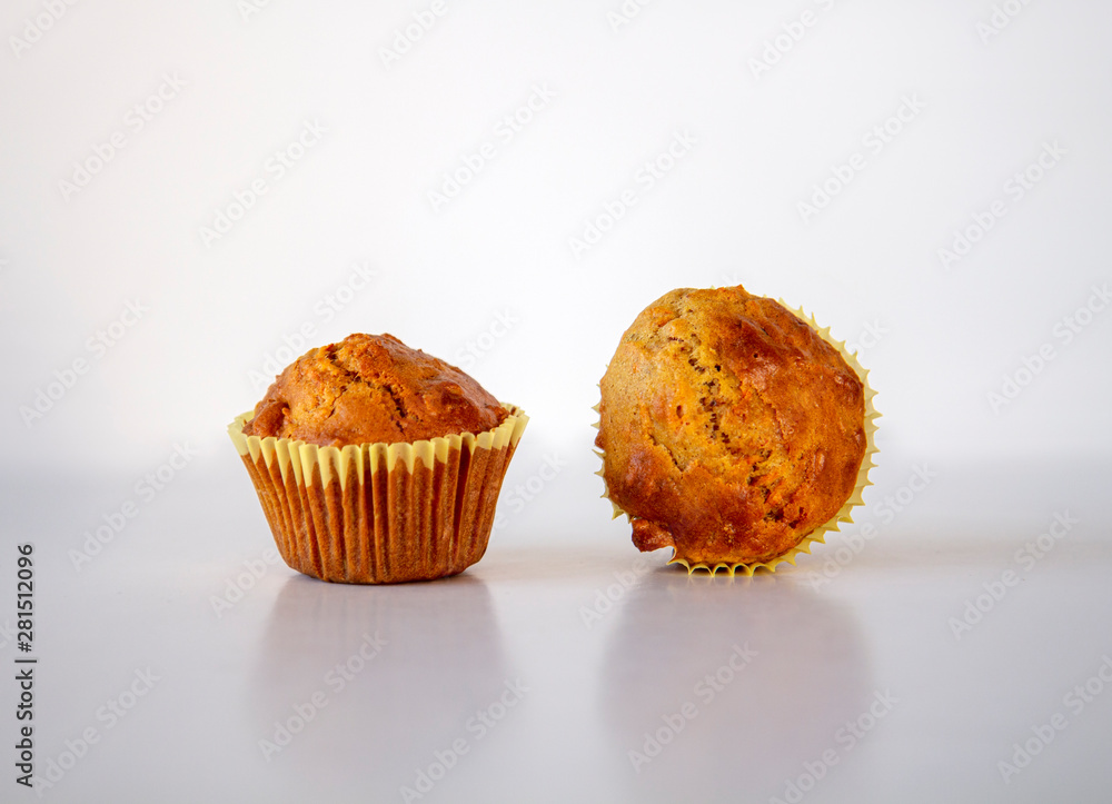 Close up of two freshly baked muffins on a white background Close up of two freshly baked muffins on a white background