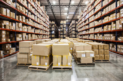 Cardboard boxes on pallets in distribution warehouse photo