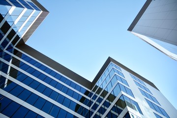 modern office building with blue sky and clouds