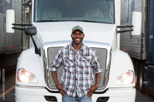 Portrait of truck driver standing near truck at truck stop photo