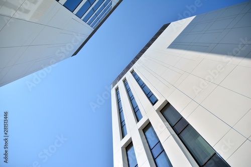 modern office building with blue sky and clouds