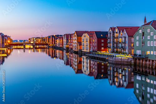 Sunset view of colorful timber houses surrounding river Nidelva in the Brygge district of Trondheim, Norway photo
