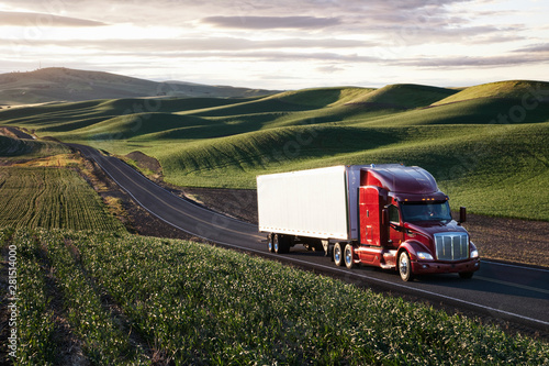 Commercial truck driving though farmland photo