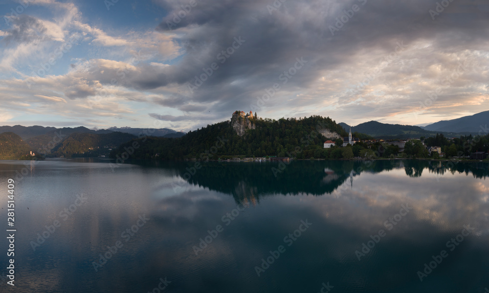 Panorama of Lake Bled with Castle, village and church on island at sunrise