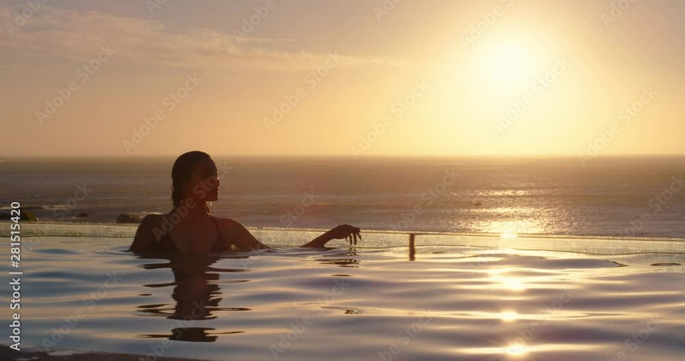 woman relaxing in swimming pool at luxury hotel spa enjoying beautiful sunset view of ocean mediterranean travel holiday resort 4k woman relaxing in swimming pool at luxury hotel spa enjoying beautiful sunset view of ocean mediterranean travel holiday resort 4k