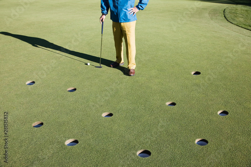 Low section of golfer standing on golf course