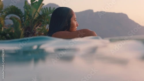 woman relaxing in swimming pool at luxury hotel spa enjoying relaxation lifestyle at sunset travel holiday resort 4k