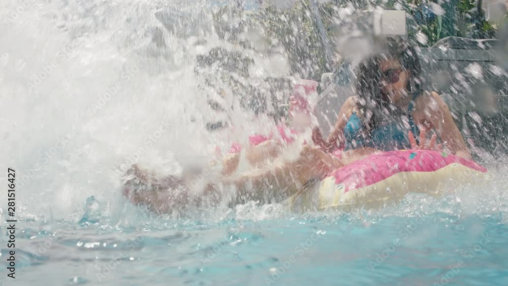 beautiful woman relaxing on swim tube in swimming pool enjoying sunny day with man jumping in water splashing girlfriend happy people having fun summer vacation 4k beautiful woman relaxing on swim tube in swimming pool enjoying sunny day with man jumping in water splashing girlfriend happy people having fun summer vacation 4k