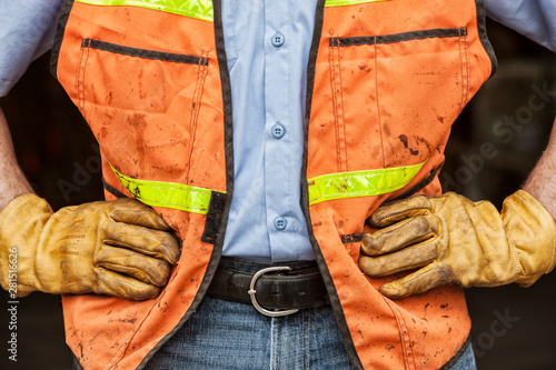 Midsection of worker wearing protective clothing and glove