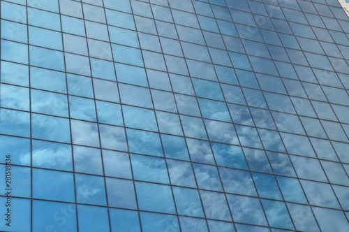 Windows of modern skyscraper with mirrored sky 