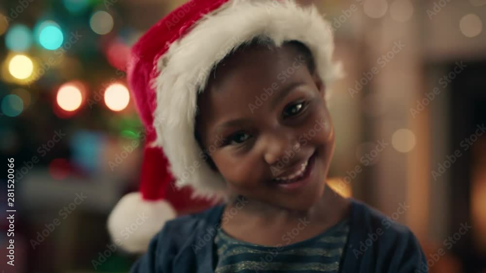 portrait little african american girl celebrating christmas wearing hat smiling enjoying festive holiday having fun evening at home 4k portrait little african american girl celebrating christmas wearing hat smiling enjoying festive holiday having fun evening at home 4k