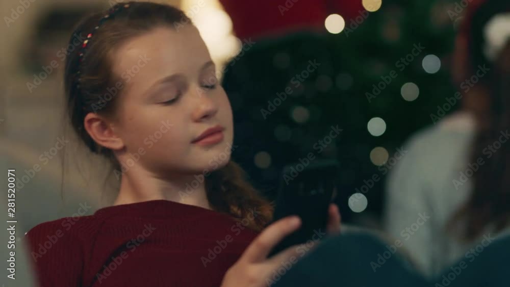antisocial teenage girl texting on smartphone at family christmas gathering bored teenager disinterested in festive celebration 4k addiction antisocial teenage girl texting on smartphone at family christmas gathering bored teenager disinterested in festive celebration 4k addiction